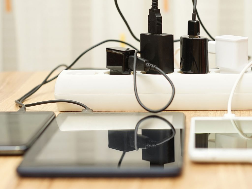 phones and tablet plugged into power strip